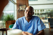 © Marko Geber - Smiling male nurse having coffee break in hospital cafeteria