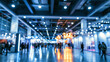 © CStock - A blurred view of an exhibition hall filled with vibrant lights and busy visitors, showcasing a lively atmosphere.