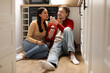 © Home-stock - Young man feeding ice cream to woman while sitting on kitchen floor