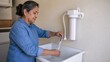 © gn8 - Forever Chemicals Older Hispanic Adult Female Homeowner Filling Sample