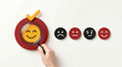 © AR  - Hand holding magnifying glass over a positive smiley face icon on a white background for feedback