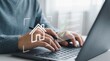 © MW Studio  - Person using laptop and stylus with digital smart home checklist interface for online real estate technology