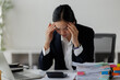 © David - Businesswoman feeling stress and headache at work