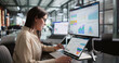 © Andrey Popov - Young Female Financial Analyst Reviewing Important KPI Data