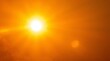 © Jacket - Intense summer sun glowing brightly in a clear orange sky creating a strong lens flare effect with radiant warmth and heat distortion for meteorological concepts