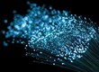© Slamet - Abstract light streaks of glowing blue fibers, bokeh effect on black background