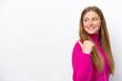 © luismolinero - Young caucasian woman isolated on white background pointing to the side to present a product
