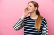 © luismolinero - Young caucasian woman isolated on pink background shouting with mouth wide open to the side