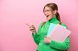 © luismolinero - Young caucasian student woman isolated on pink background pointing finger to the side and presenting a product