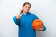 © luismolinero - Young caucasian woman playing basketball isolated on white background smiling and showing victory sign