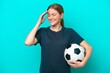 © luismolinero - Young football player woman isolated on blue background smiling a lot