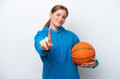 © luismolinero - Young caucasian woman playing basketball isolated on white background showing and lifting a finger