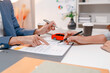 © PHOTO4U - Professional car sales consultation with a customer reviewing documents, discussing vehicle options, signing purchase agreements, and handing over car keys in a modern dealership office.