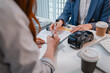 © PHOTO4U - Car purchase transaction with payment, contract signing, key handover, and customer agreement in a modern dealership office, representing automotive sales, business finance, and professional service.