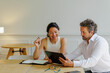 © BONNINSTUDIO/Stocksy - Professionals collaborating on digital tablet in modern workspace