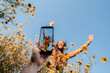 © Lucas Ottone/Stocksy - Person filming a mobile video of a smiling friend
