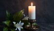 © kl yanii - Single lit candle in ornate holder on dark surface. White lily flowers and green leaves beside candle