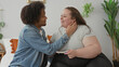 © Krakenimages.com - Man and plus size woman sit on a bed, man cups woman's face and kisses her while she holds a pregnancy test in a studio; expectant joy.