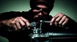 © Evarelle - Close up of a mechanic hands using wrenches on a metal component. Dramatic lighting on manual worker repairing machinery. Engineering and maintenance concept