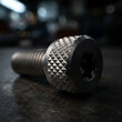 © MD JEGON - Industrial titanium bolt with knurled head and hex socket resting on metal