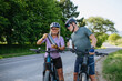 © Halfpoint - Mature couple resting and drinking water on electric bike tour.