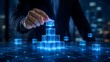 © Ahmed - Digital business architecture and tech foundation concept with a hand building a glowing blue holographic cube pyramid