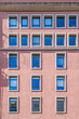 © ikuday - Barcelona, Symmetric Windows on Pink Building Facade, Modern Geometric Architecture, Minimalist Urban Apartment Exterior