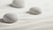 © Hot - smooth natural stones on fine sand, zen minimalism, soft side lighting, realistic textures, peaceful composition, space, ultra detailed commercial