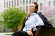 © BusinessClass by W61 - Confident businesswoman takes a break on an outdoor bench