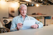 © BusinessClass by W61 - Businessman reviews a document at his office desk
