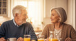 © SYATRI RAWU - Happy senior couple sitting at a breakfast table in a sunlit kitchen, looking lovingly at each other while enjoying morning juice and coffee at home.
