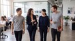 © Chan จันทร์ - Diverse business team walking and talking in modern office