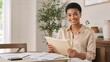 © Vasiliy - Smiling young Black businesswoman holding a folder at a desk. Happy female professional working with documents in a bright office. Entrepreneurship and success concept