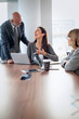 © gzorgz - Business colleagues discussing ideas in modern office