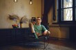 © Aleksei Isachenko/imageBROKER - A middle-aged man sits in a chair and looks at the smartphone screen. He made an online order and checks the stage of delivery procedure
