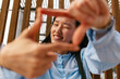 © ADDICTIVE STOCK - Businesswoman smiling while framing with hands