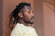 © ADDICTIVE STOCK - Cuban man in profile with dreadlock hairstyle outdoors