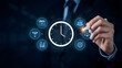 © Background - Close up of a businessman hand using a stylus pen to select a time management from a circular digital interface with various business symbols