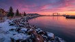 © Serhii - Winter harbor scene in Duluth, Minnesota with snow-covered shoreline and distant lift bridge at sunrise