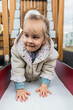 © ADDICTIVE STOCK - Blonde girl exploring playground with joy