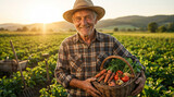 Smiling senior male farmer wearing a straw hat proudly holding a woven basket filled with fresh organic vegetables while standing in a beautiful green field at sunset.