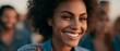 © progressman - Happy young woman with curly hair smiles in social setting