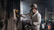 © tangmo.pa - Professional Fire Damage Restoration Technician Cleaning Soot Off Wall