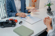 © PHOTO4U - Professional car sales consultation with a customer reviewing documents, discussing vehicle options, signing purchase agreements, and handing over car keys in a modern dealership office.