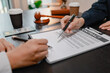 © PHOTO4U - Professional legal consultation with a lawyer explaining legal procedures, reviewing contracts, and advising clients during a case discussion in a modern law office, representing justice and trust.