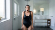 © Светлана Волынкина - Woman under cold shower with wet hair and energized expression in modern tiled bathroom. Cold shower wellness concept