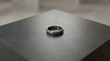© ravikanth - Polished silver wedding band on dark gray slate surface with blurred background elegant metallic ring for engagement jewelry product photography luxury minimalist accessory jewelry shop.