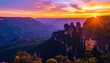 © Udin - Vibrant sunset paints the sky over dramatic rock formations in a mountainous landscape.