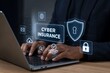 © Meea - Hands typing on laptop with cyber insurance holographic interface and security icons