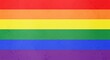 © Shibly Sadik - Bright rainbow flag with a subtle grunge texture background representing pride and equality for the LGBTQ community